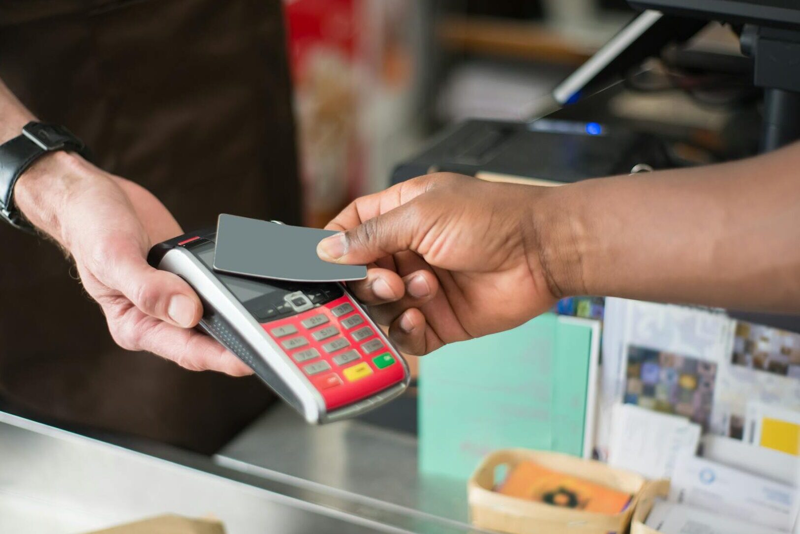 pexels photo 8475145 8475145 Close-up of a contactless payment transaction in a retail setting.